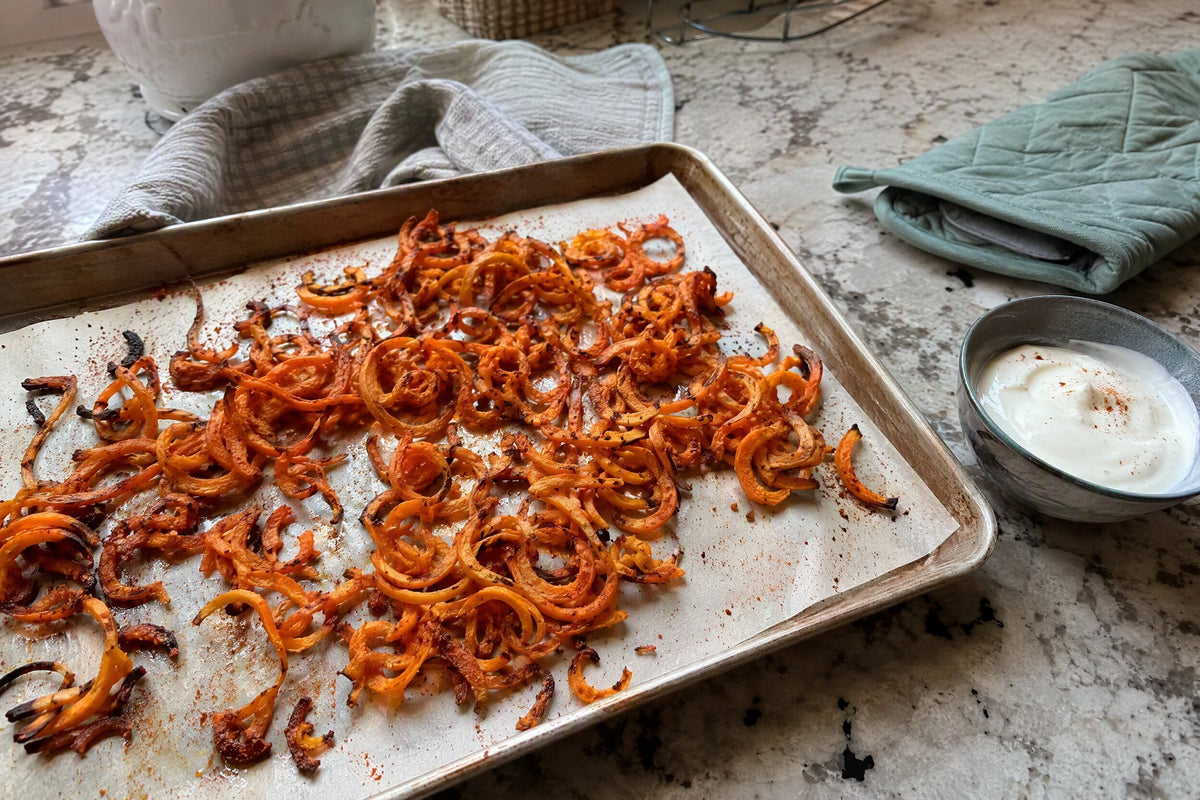 Baked curly sweet potato fries with paprika served with a dip