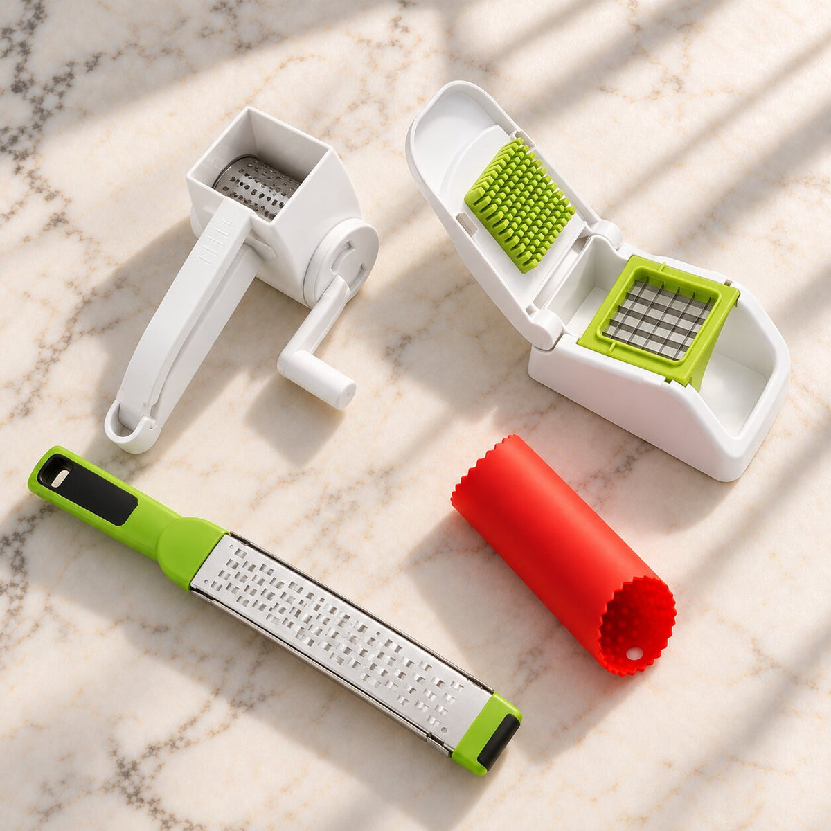 Götze Thanksgiving Prep Kit: rotary grater, food dicer, zester and garlic peeler on a marble countertop