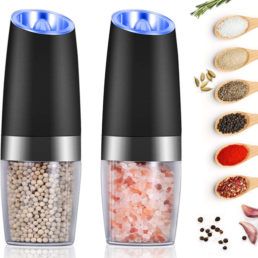 Black electric pepper and salt grinder set with clear spice chambers, stainless steel accents, and illuminated grinding tops, shown with assorted seasonings.