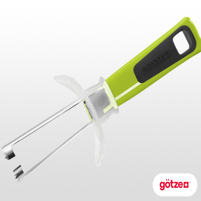 Götze guarded apple corer with green and black ergonomic handle, dual stainless steel coring blades, and clear protective safety guard on a white background.