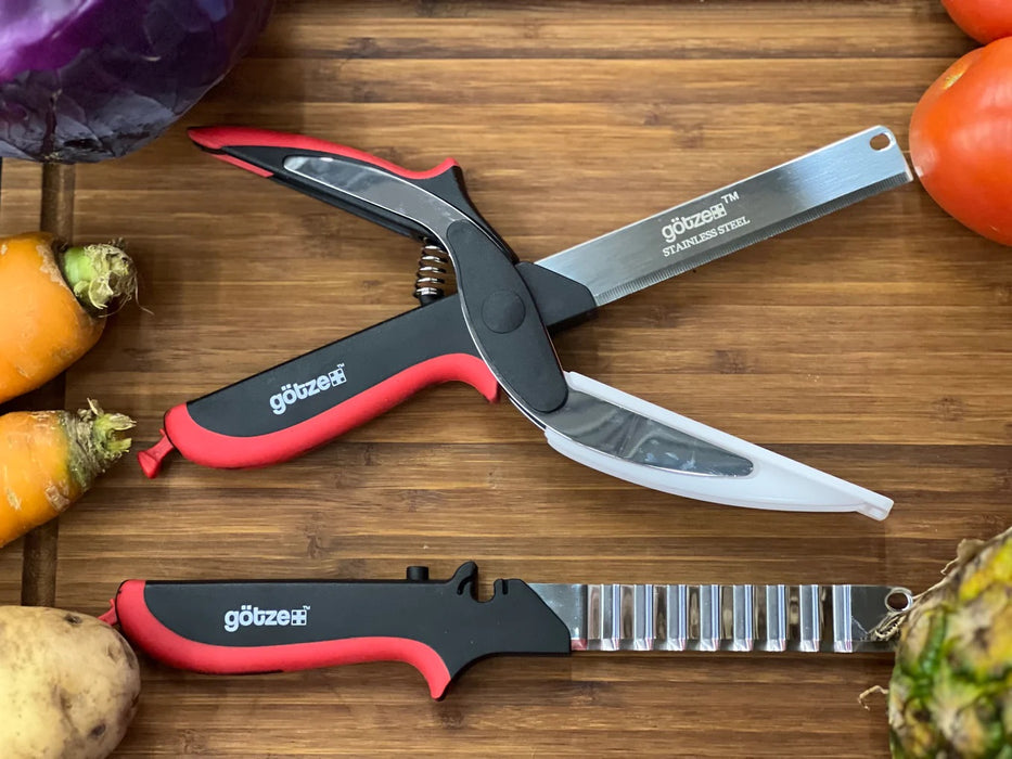 Götze Limited Bundle multi-function stainless steel kitchen shears and crinkle cutter displayed on a wooden cutting board surrounded by fresh vegetables.