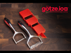 Götze Luxury Premium Peeler with a red handheld slicer displayed on a dark wooden cutting board.