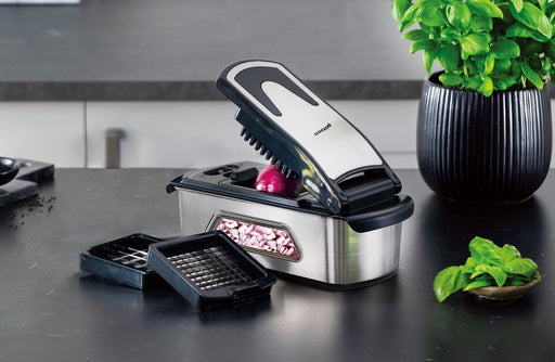 Götze Premium Stainless Steel Food Chopper with interchangeable dicing blades chopping red onion on a modern kitchen countertop.