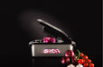 Götze Premium Stainless Steel Food Chopper dicing red onion into even pieces, displayed with fresh onions, tomatoes, and garlic on a dark background.