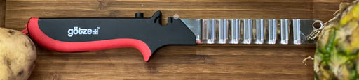Götze Replacement Wavy Blade for Kitchen Shears with a black and red ergonomic handle displayed on a wooden cutting board.