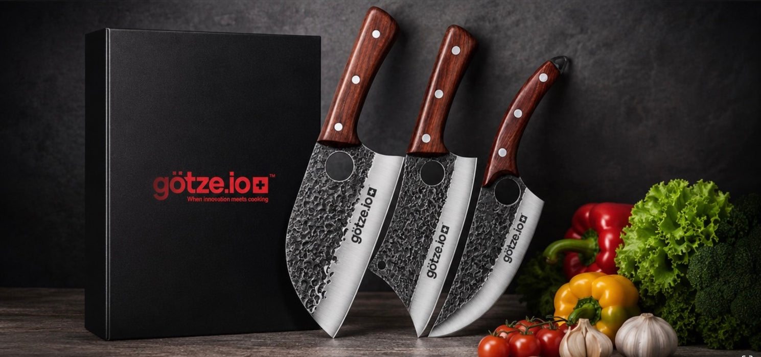 Götze Signature 3-Piece  hammered stainless steel kitchen knife set with wooden handles, black gift box, and fresh vegetables displayed on a dark kitchen background.