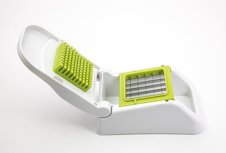 Götze FreshCut Food Dicer with white hinged press, green stainless steel cutting grid, and built-in collection base on a white background.