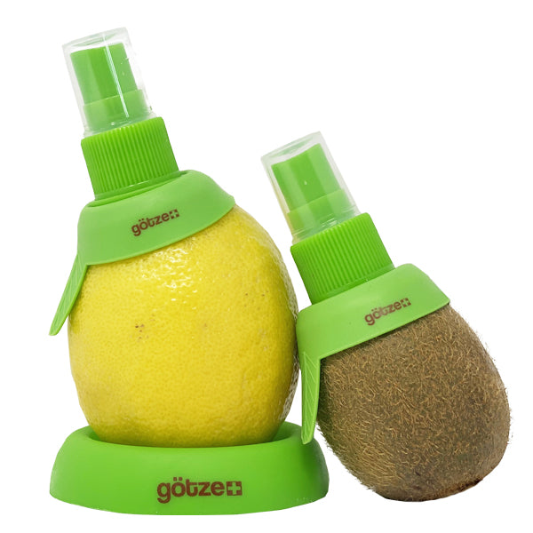 Götze green citrus spritzer attachments inserted into a lemon and kiwi, with matching storage base for spraying fresh fruit juice directly from the fruit.