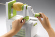 Götze Premium Vegetable Spiralizer being used with a potato, featuring a hand crank, secure food holder, slicing blade, and built-in storage base.