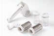 Götze rotary grater set with hand crank, two interchangeable stainless steel grating drums, and two clear storage containers on a white background.