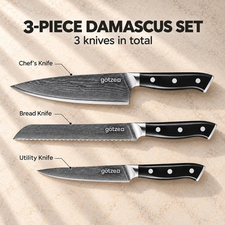 Götze 3-piece Damascus knife set: chef's knife, bread knife and utility knife labeled on a stone countertop