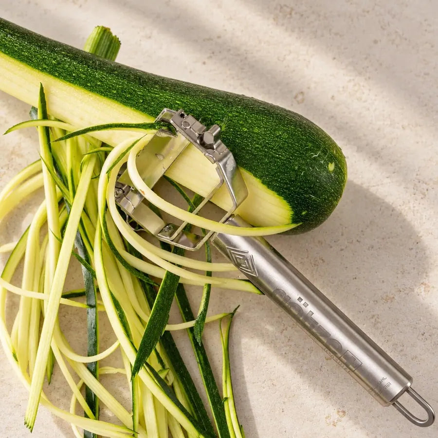 Götze julienne peeler turning a zucchini into thin noodle strands